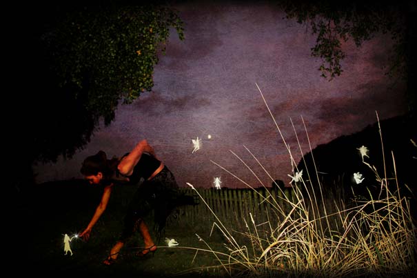 Person reaching out to glowing fairy-like figures in a dark outdoor setting, illustrating interesting facts about dreams. Person reaching out to glowing fairy-like figures in a dark outdoor setting, illustrating interesting facts about dreams.
