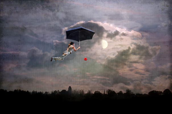 Woman floating in a cloudy night sky holding an umbrella, symbolizing creative and surreal dreams.