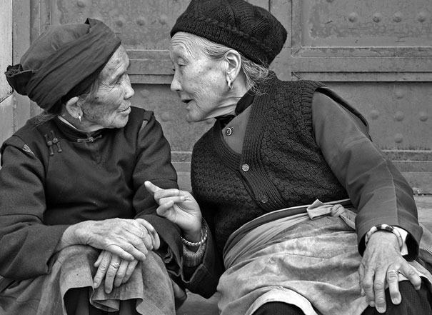 Two women sharing a joyful conversation, creating a moment of happiness and connection.