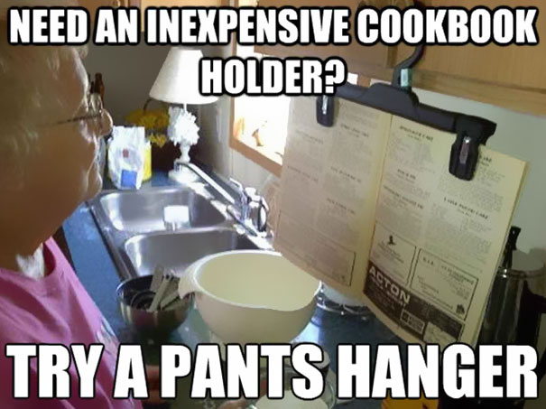 Woman using a cloth hanger to read a newspaper Woman using a cloth hanger to read a newspaper