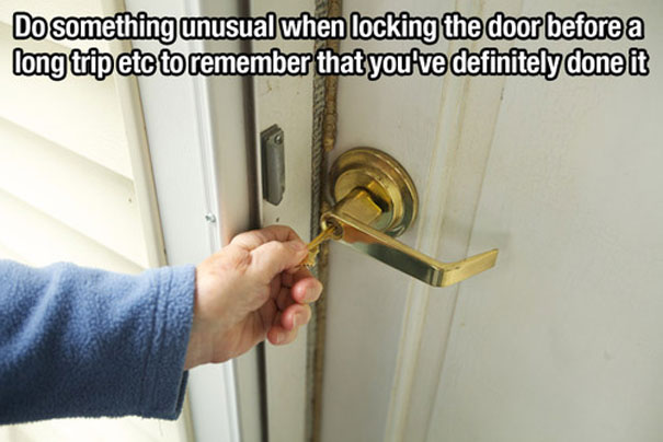 Person unlocking locked door with a key Person unlocking locked door with a key