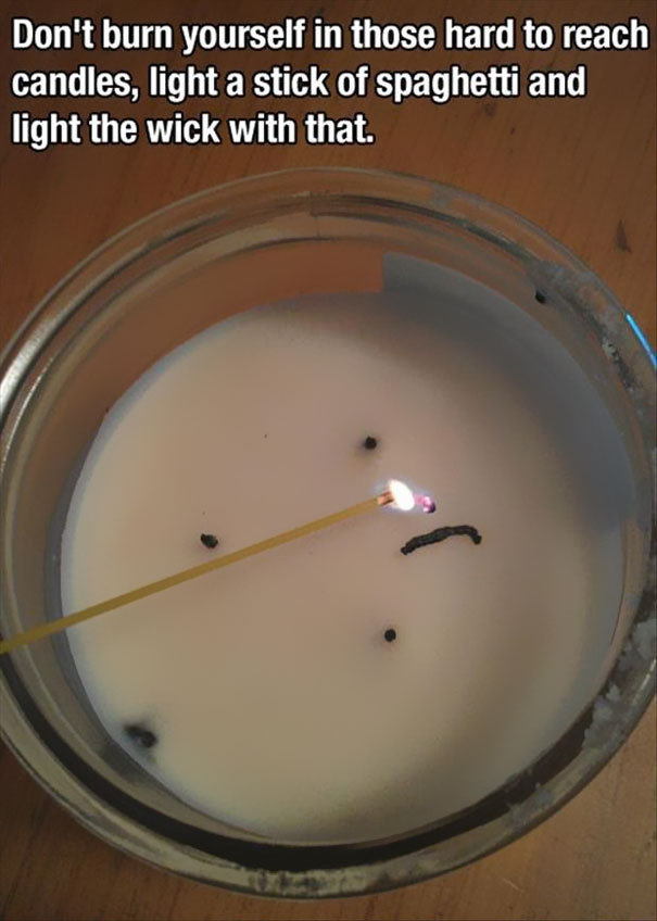 Person using a spaghetti to light up the candle Person using a spaghetti to light up the candle