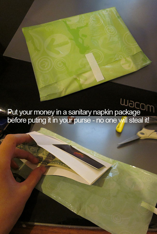 Person putting money in a sanitary napkin package Person putting money in a sanitary napkin package