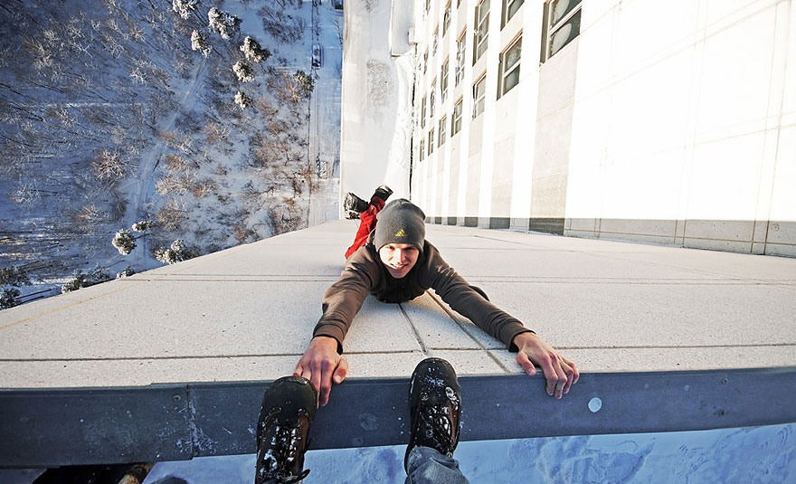 Dizzying Photos of Ukrainian Daredevil Hanging from Tall Buildings Dizzying Photos of Ukrainian Daredevil Hanging from Tall Buildings