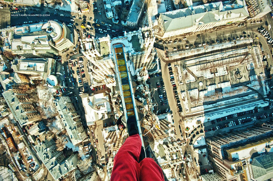 Dizzying Photos of Ukrainian Daredevil Hanging from Tall Buildings Dizzying Photos of Ukrainian Daredevil Hanging from Tall Buildings