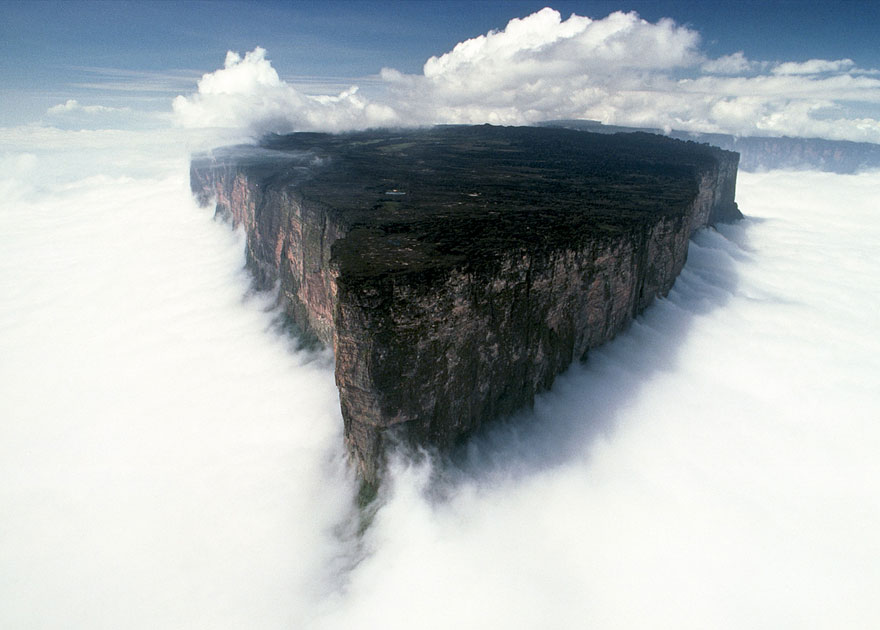 Breathtaking view of Mount Roraima, a must-visit place, emerging above the clouds with sheer cliffs and a flat summit. Breathtaking view of Mount Roraima, a must-visit place, emerging above the clouds with sheer cliffs and a flat summit.