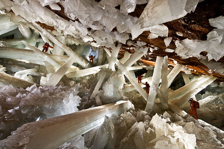 Giant crystal cave with explorers in protective suits, showcasing one of the unbelievable places to visit. Giant crystal cave with explorers in protective suits, showcasing one of the unbelievable places to visit.