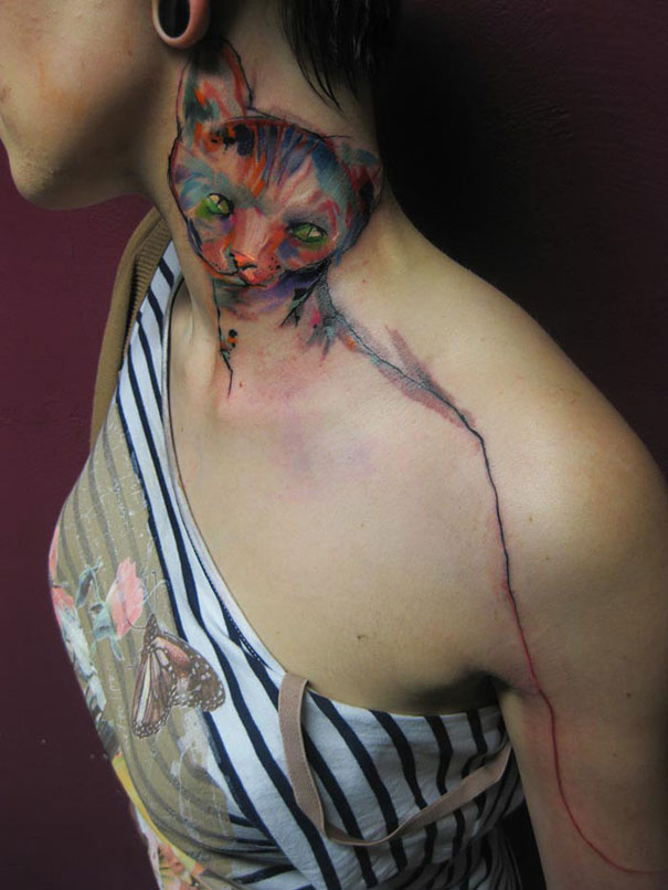 Artistic watercolor tattoo of a cat on a person's neck and shoulder. Artistic watercolor tattoo of a cat on a person's neck and shoulder.